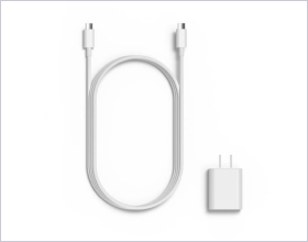 White USB-C charging cable coiled in an oval shape with connectors at both ends placed next to a compact white power adapter on a clean white background creating a minimal and modern atmosphere