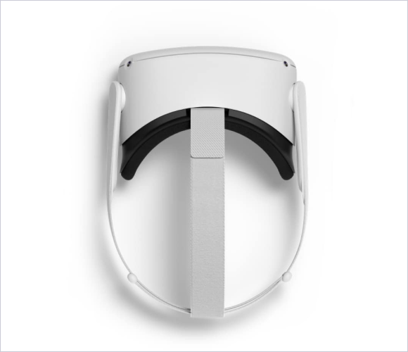 White virtual reality headset viewed from above with a head strap extending downward, resting on a clean white surface, creating a modern and minimalistic atmosphere